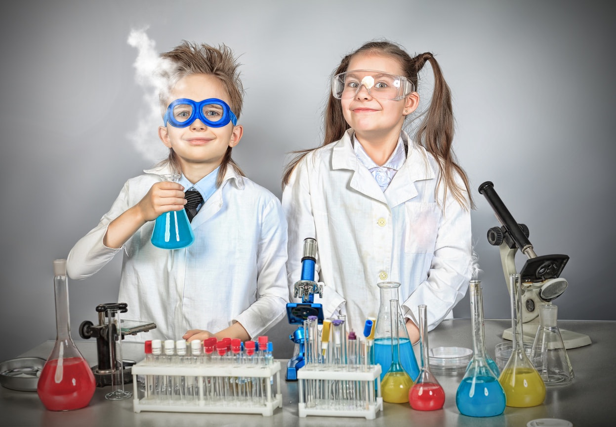 two young kids in a laboratory as part of a current events happening in the museum